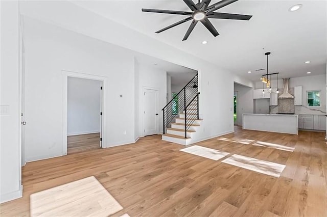 1835 Taylor Ave, East Point, GA 30344 - unfurnished living room featuring ceiling fan, light wood-type flooring, recessed lighting, and stairway