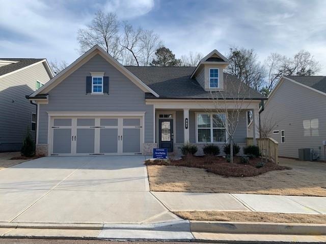 view of front of property with a front yard, a porch, and a garage