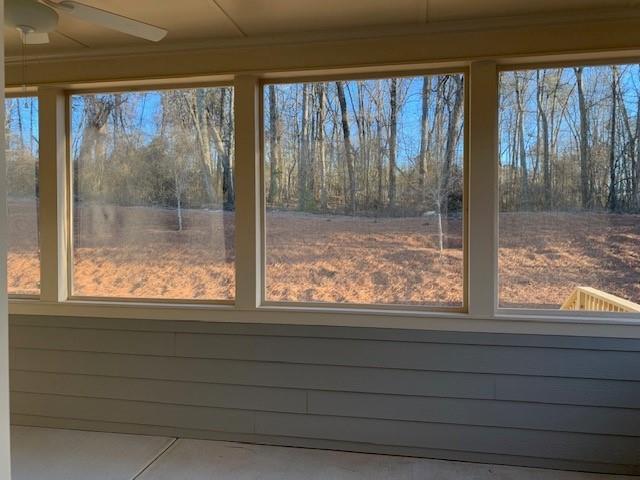 spare room with dark hardwood / wood-style floors, plenty of natural light, and ornamental molding