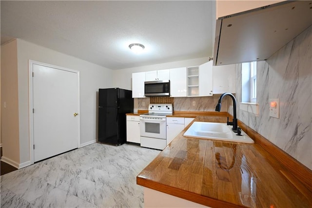 kitchen featuring wood counters, black refrigerator, sink, white electric range oven, and white cabinetry