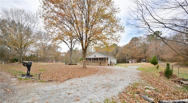 view of road with gravel driveway