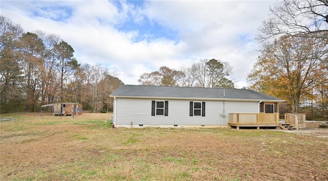 back of house with crawl space, a lawn, and a wooden deck