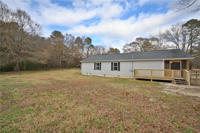 back of house with crawl space, a yard, and a wooden deck