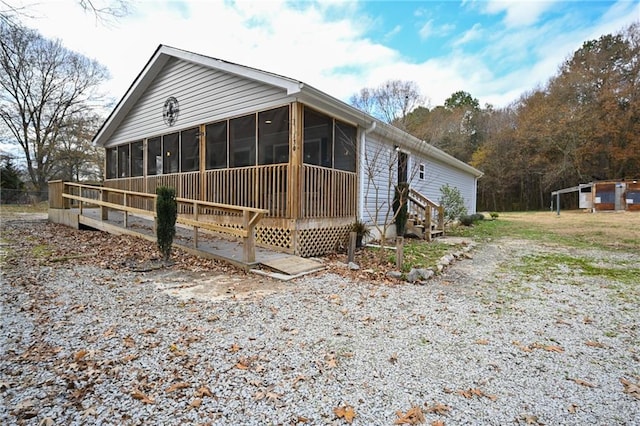 view of home's exterior featuring a sunroom