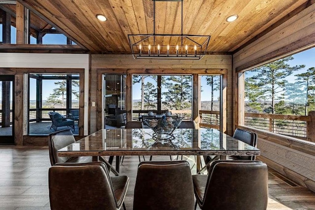 sunroom / solarium with a notable chandelier, plenty of natural light, and wooden ceiling