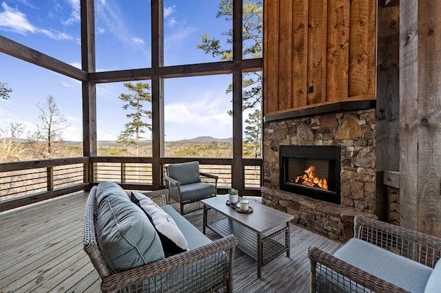 sunroom with a stone fireplace