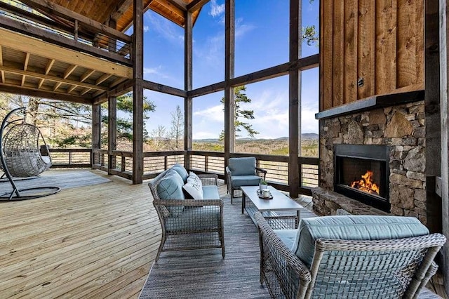 sunroom / solarium with an outdoor stone fireplace