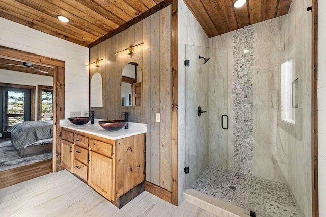 bathroom featuring vanity, wooden walls, wood ceiling, and a shower with shower door