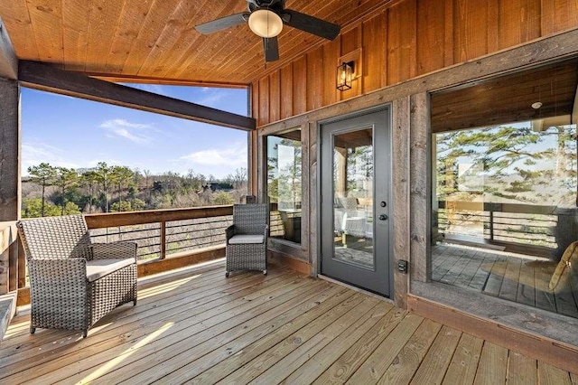 wooden deck featuring ceiling fan