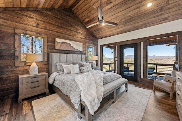 bedroom featuring access to exterior, a mountain view, hardwood / wood-style floors, and wooden ceiling