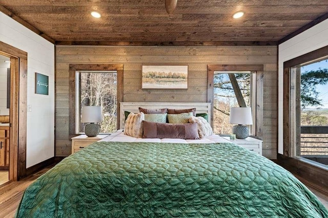 bedroom featuring access to exterior, wood ceiling, wood-type flooring, and wooden walls