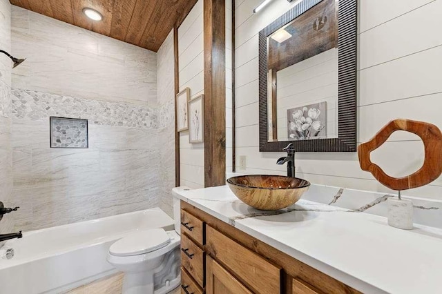 full bathroom featuring tile walls, tiled shower / bath combo, vanity, wooden ceiling, and toilet