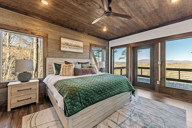 bedroom with wood ceiling, wood walls, dark hardwood / wood-style floors, and access to outside