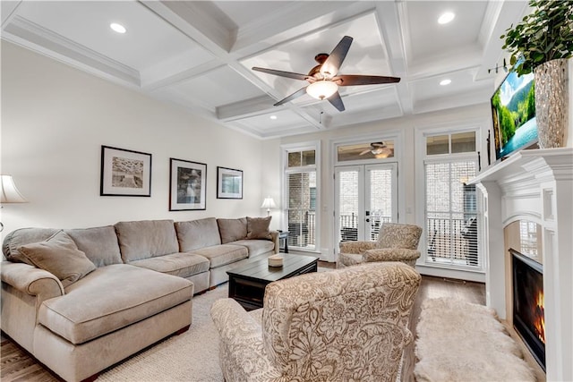 living room featuring beam ceiling, coffered ceiling, and light wood-type flooring