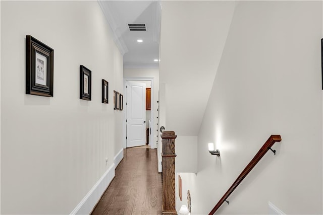 hallway featuring ornamental molding and dark hardwood / wood-style flooring