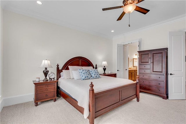 bedroom with ensuite bathroom, crown molding, light colored carpet, and ceiling fan