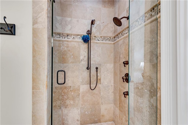 bathroom with a shower with door