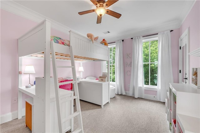 bedroom featuring ornamental molding, light colored carpet, and ceiling fan