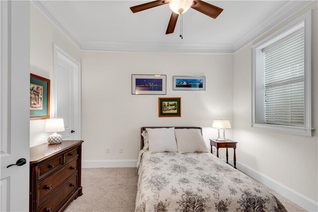 carpeted bedroom with ceiling fan and ornamental molding