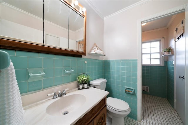 bathroom with vanity, ornamental molding, tile patterned floors, tile walls, and toilet