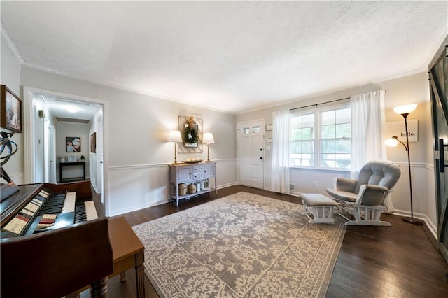 living area with a textured ceiling, dark hardwood / wood-style floors, and crown molding