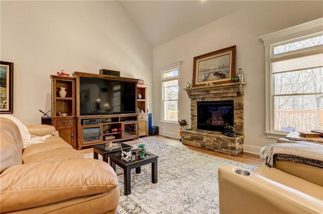 103 Old Avery Dr, Canton, GA 30115 - living area with lofted ceiling, a stone fireplace, wood finished floors, and baseboards