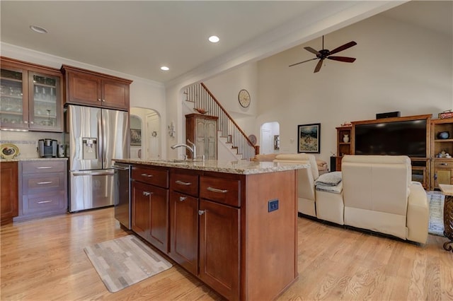 103 Old Avery Dr, Canton, GA 30115 - kitchen featuring arched walkways, appliances with stainless steel finishes, a ceiling fan, a sink, and light wood-type flooring