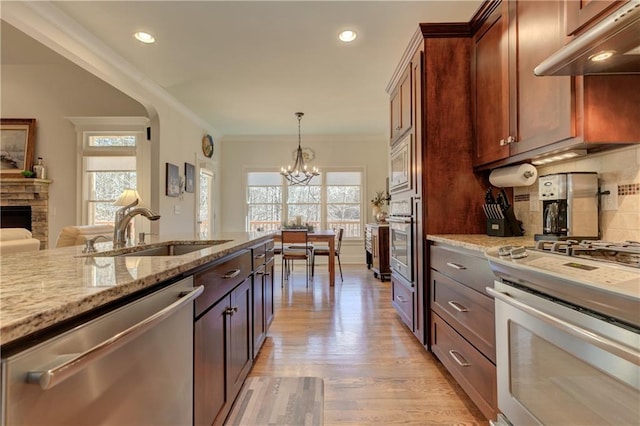 103 Old Avery Dr, Canton, GA 30115 - kitchen featuring appliances with stainless steel finishes, a sink, under cabinet range hood, a chandelier, and light stone countertops