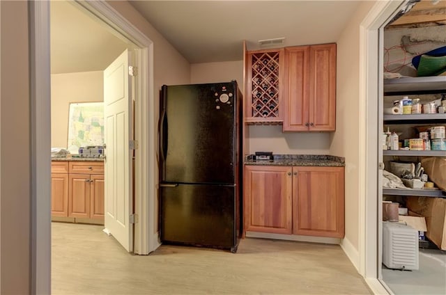 103 Old Avery Dr, Canton, GA 30115 - kitchen featuring freestanding refrigerator, light wood-style floors, and dark stone counters