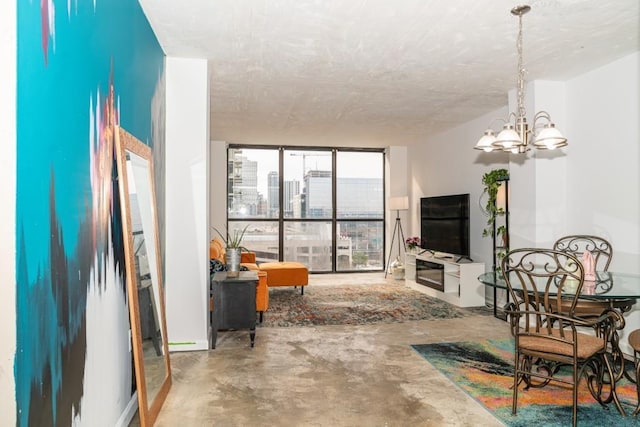 living room featuring concrete flooring and an inviting chandelier