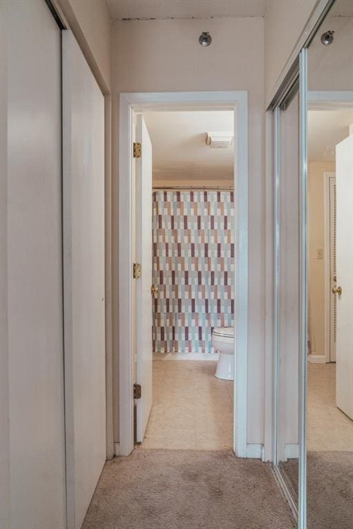 hallway with light colored carpet