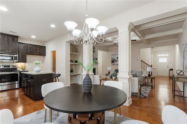 dining area featuring decorative columns, coffered ceiling, beamed ceiling, a chandelier, and dark hardwood / wood-style floors