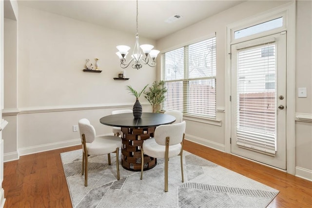 dining room featuring a chandelier and hardwood / wood-style flooring