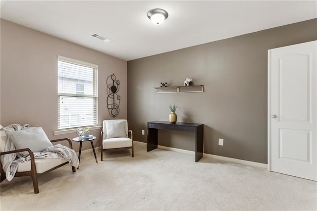 living area featuring light colored carpet