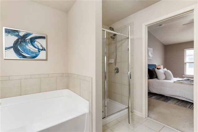 bathroom with separate shower and tub and tile patterned flooring