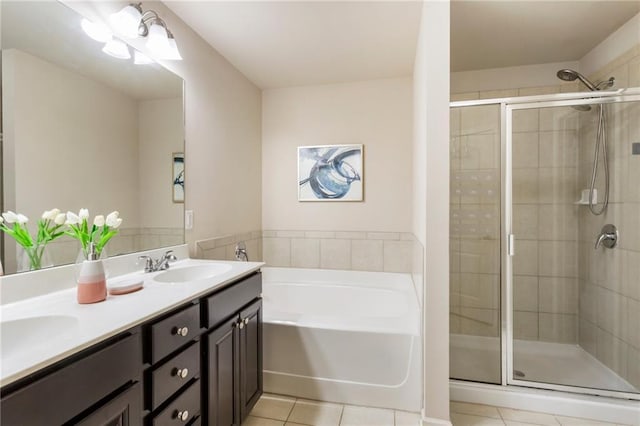 bathroom with tile patterned flooring, vanity, and plus walk in shower