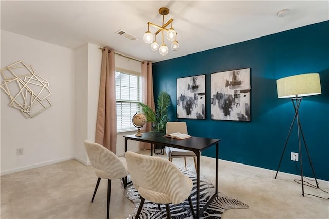 carpeted home office with an inviting chandelier