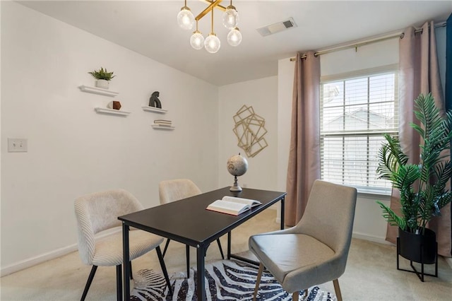 dining space featuring light carpet, a chandelier, and a healthy amount of sunlight