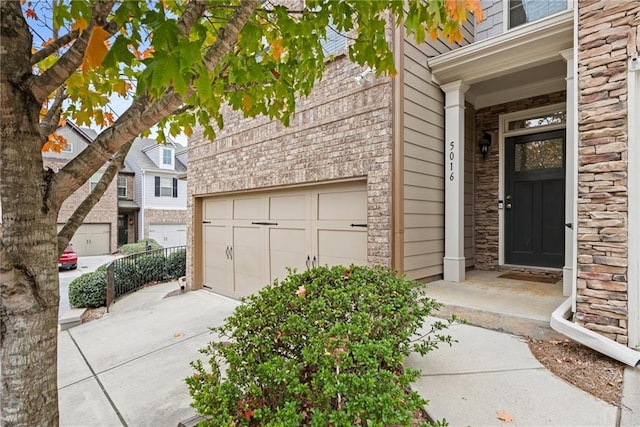 doorway to property with a garage