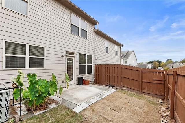 rear view of property featuring central air condition unit and a patio area