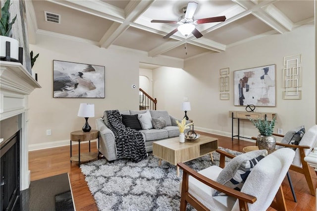 living room with coffered ceiling, ceiling fan, crown molding, beam ceiling, and hardwood / wood-style flooring