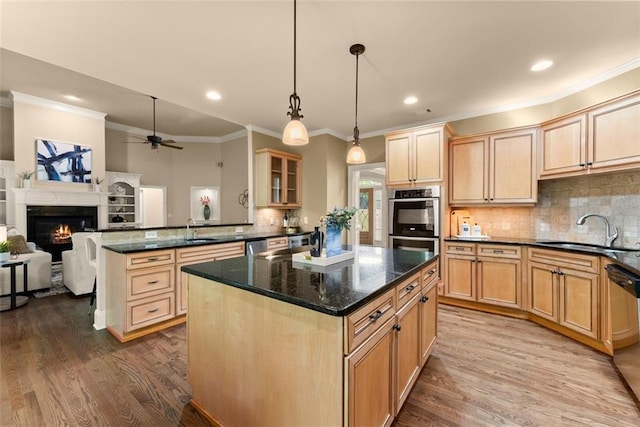 kitchen featuring a sink, a center island, and wood finished floors