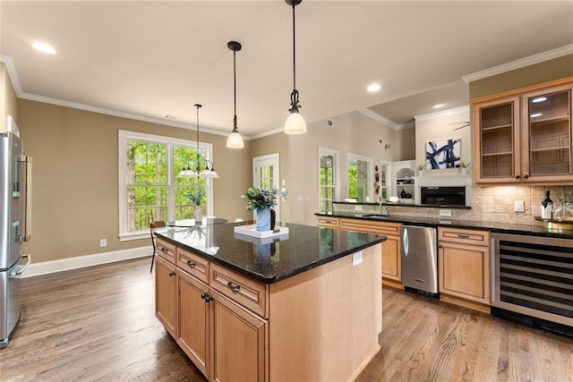 kitchen featuring backsplash, refrigerator, beverage cooler, and wood finished floors