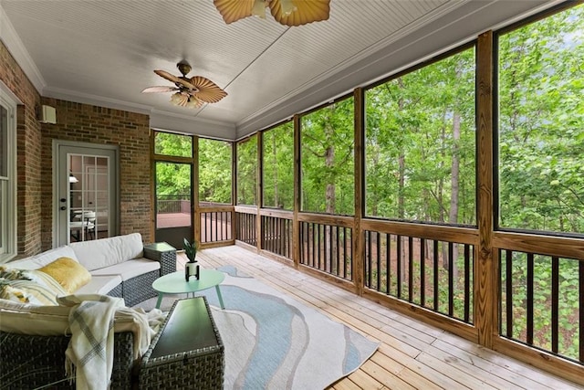 sunroom / solarium with a ceiling fan and an outdoor hangout area