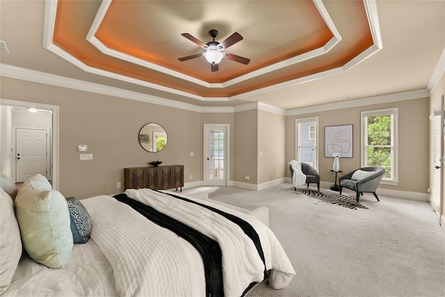 bedroom with carpet floors, baseboards, ceiling fan, and a raised ceiling