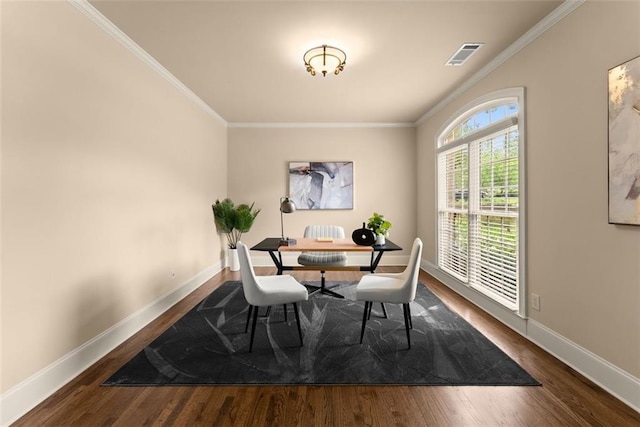 dining area with visible vents, baseboards, crown molding, and wood finished floors