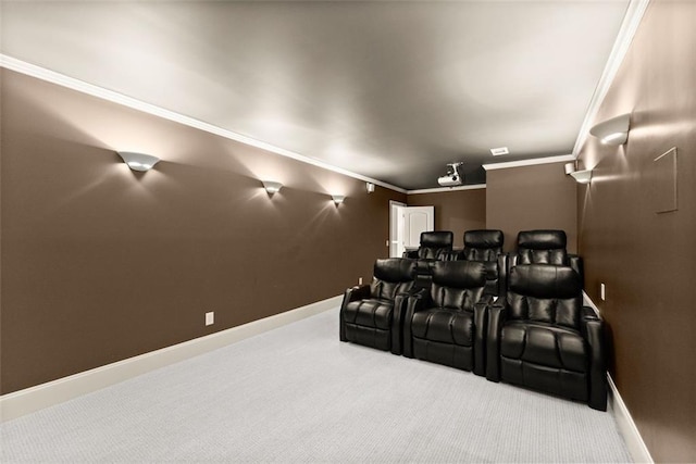 carpeted cinema room with crown molding and baseboards