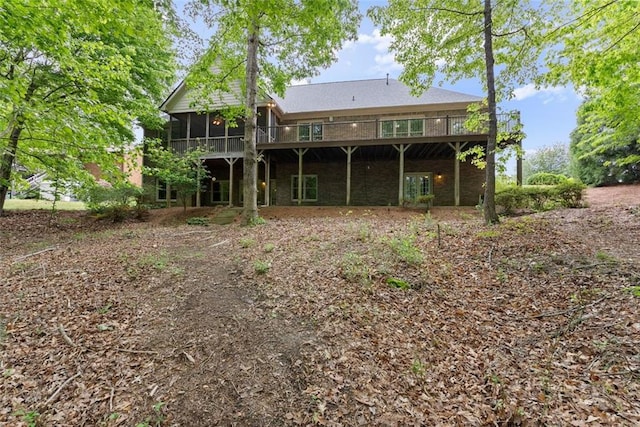 back of house featuring a sunroom and a deck