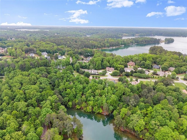 drone / aerial view featuring a water view and a view of trees