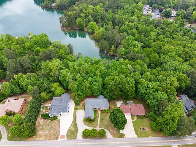 aerial view with a water view and a forest view